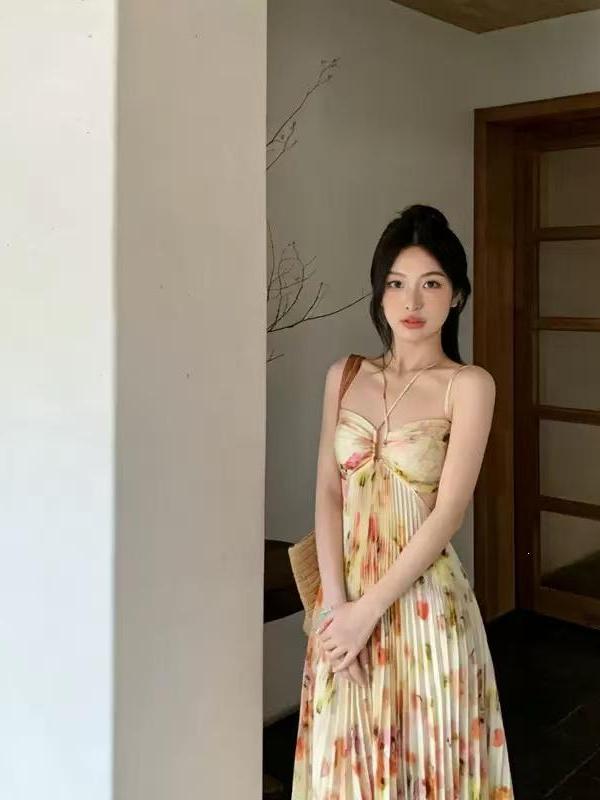 Lace-up halterneck cutout pleated floral maxi dress in pastel yellow and cream tones