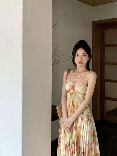 Lace-up halterneck cutout pleated floral maxi dress in pastel yellow and cream tones