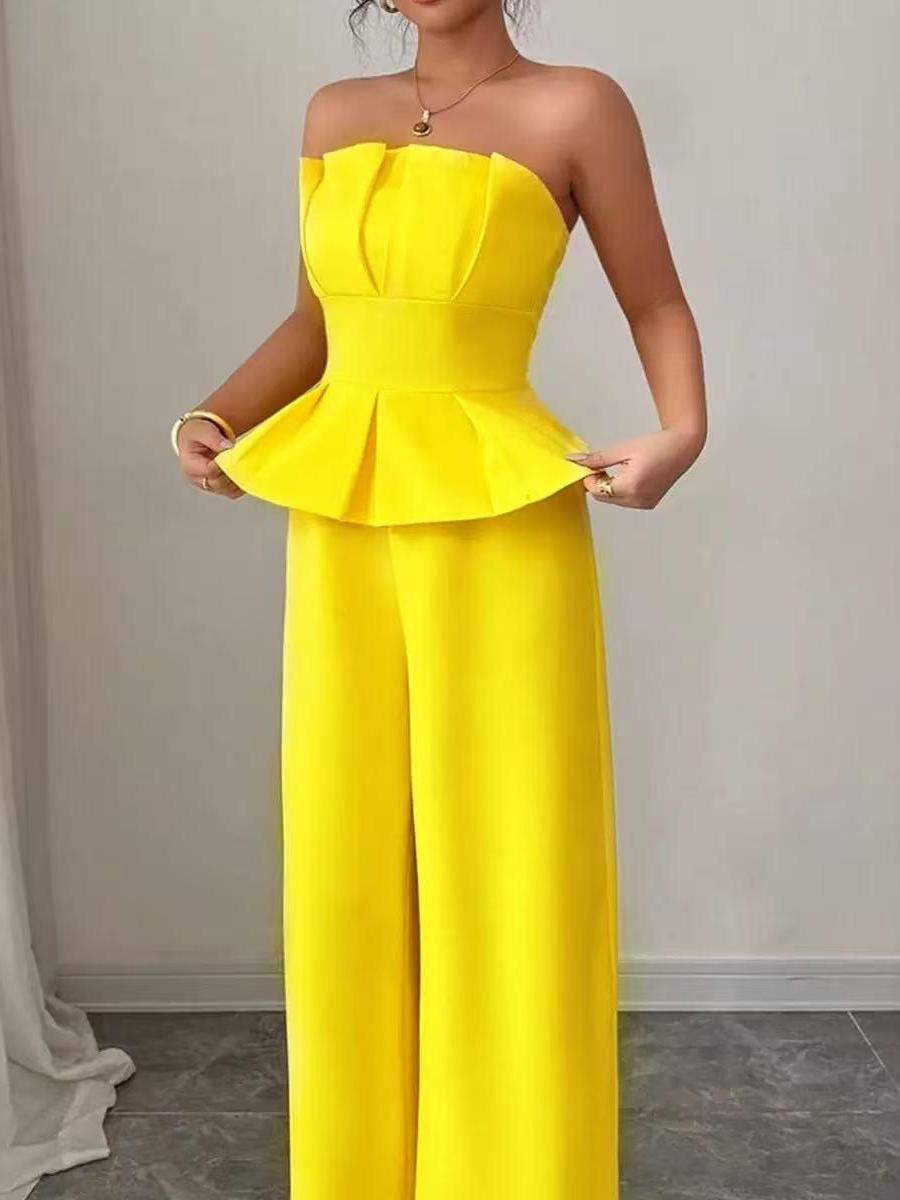 Bright yellow strapless peplum jumpsuit with a structured bodice, flared peplum waist, and wide-leg pants.