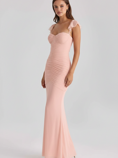 Blush Muse Ruched Mermaid Maxi Dress in blush pink with sheer flutter sleeves and mermaid silhouette