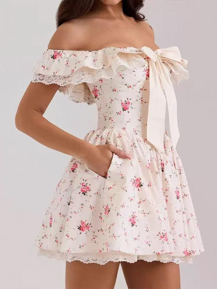 Cream off-shoulder floral mini dress with lace ruffle, large front bow, pink rose print, and pockets.