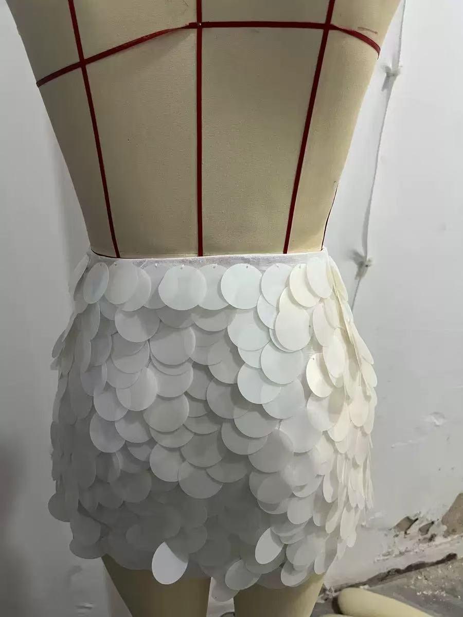 Coin Shell Mini Skirt by Exclusives; white overlapping sequins create a textured, scalloped hem