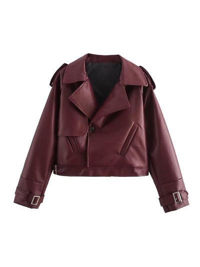Burgundy PU leather cropped jacket with wide lapels, single button closure, angled pockets, belted hem, buckle cuffs.