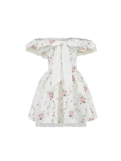 White off-shoulder mini dress with pink rose print, ruffled neckline, lace trim, and a large front bow.
