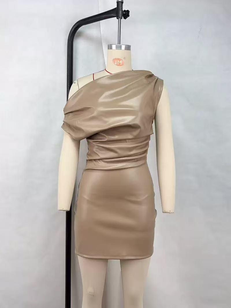 Taupe faux-leather mini dress with an asymmetric, one-shoulder draped bodice on a mannequin.
