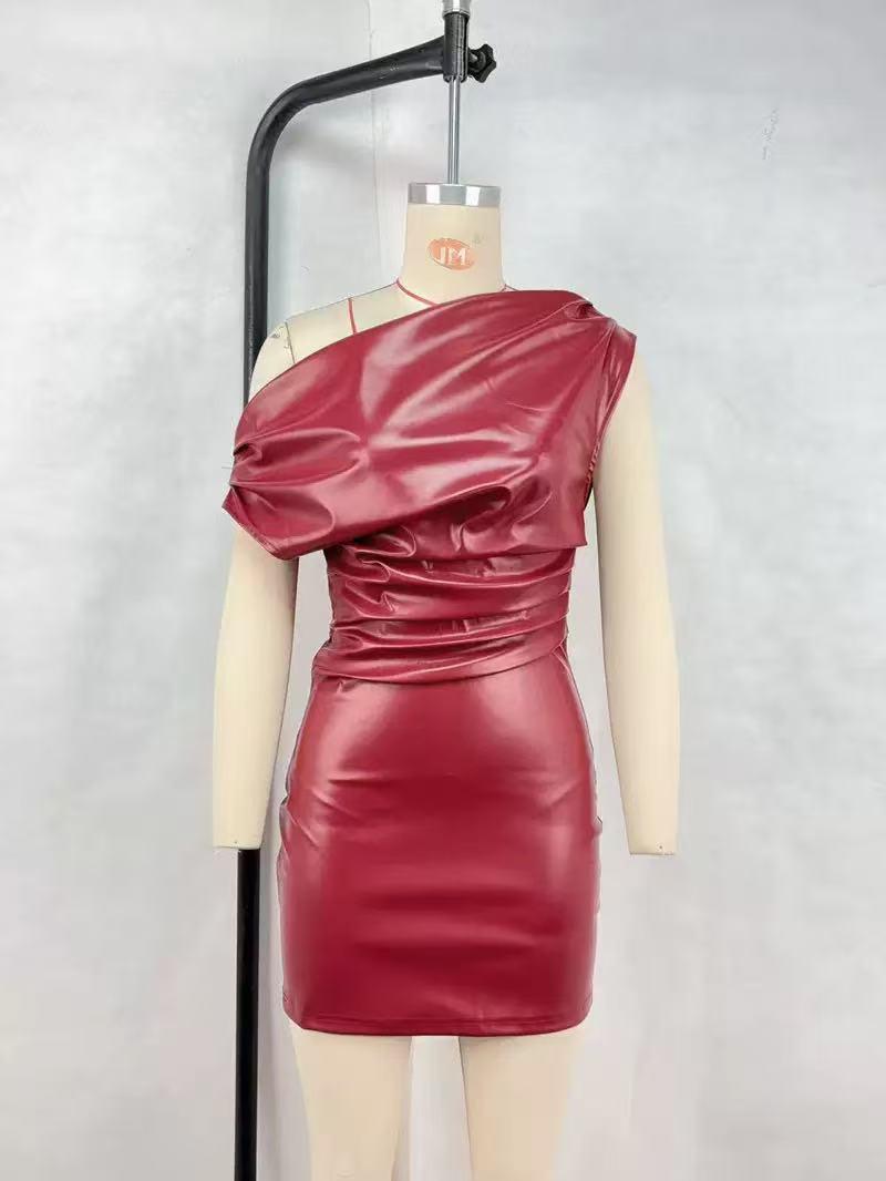 Wine-red faux-leather one-shoulder mini dress with a draped bodice and ruched waist on a mannequin