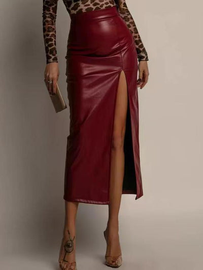 Wine-red faux-leather pencil midi skirt with a high slit, paired with a leopard-print long-sleeve top and nude heels.