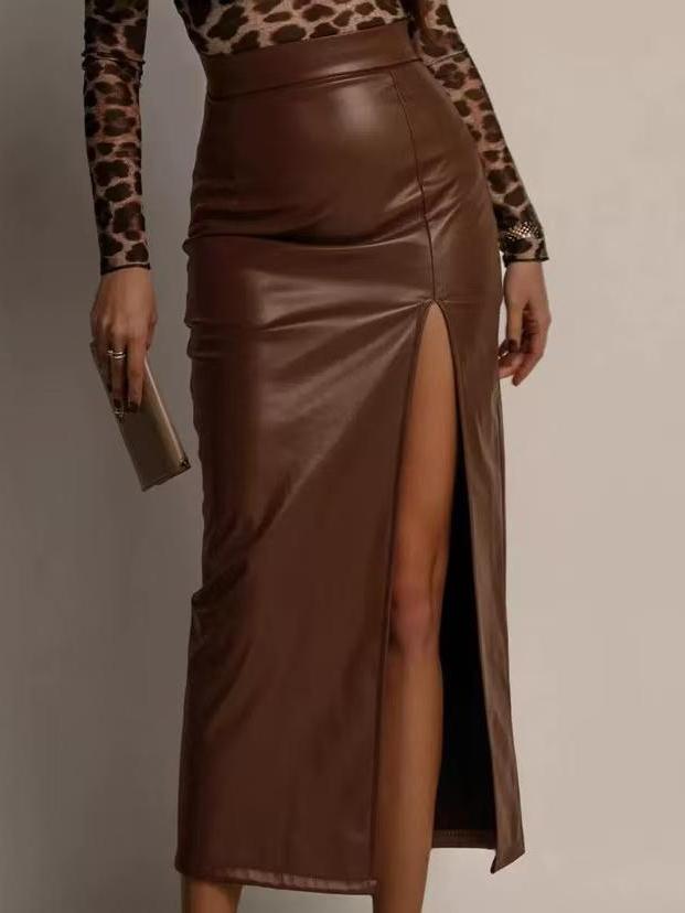 Brown glossy faux-leather pencil midi skirt with a high slit, worn with a leopard-print top and beige clutch.