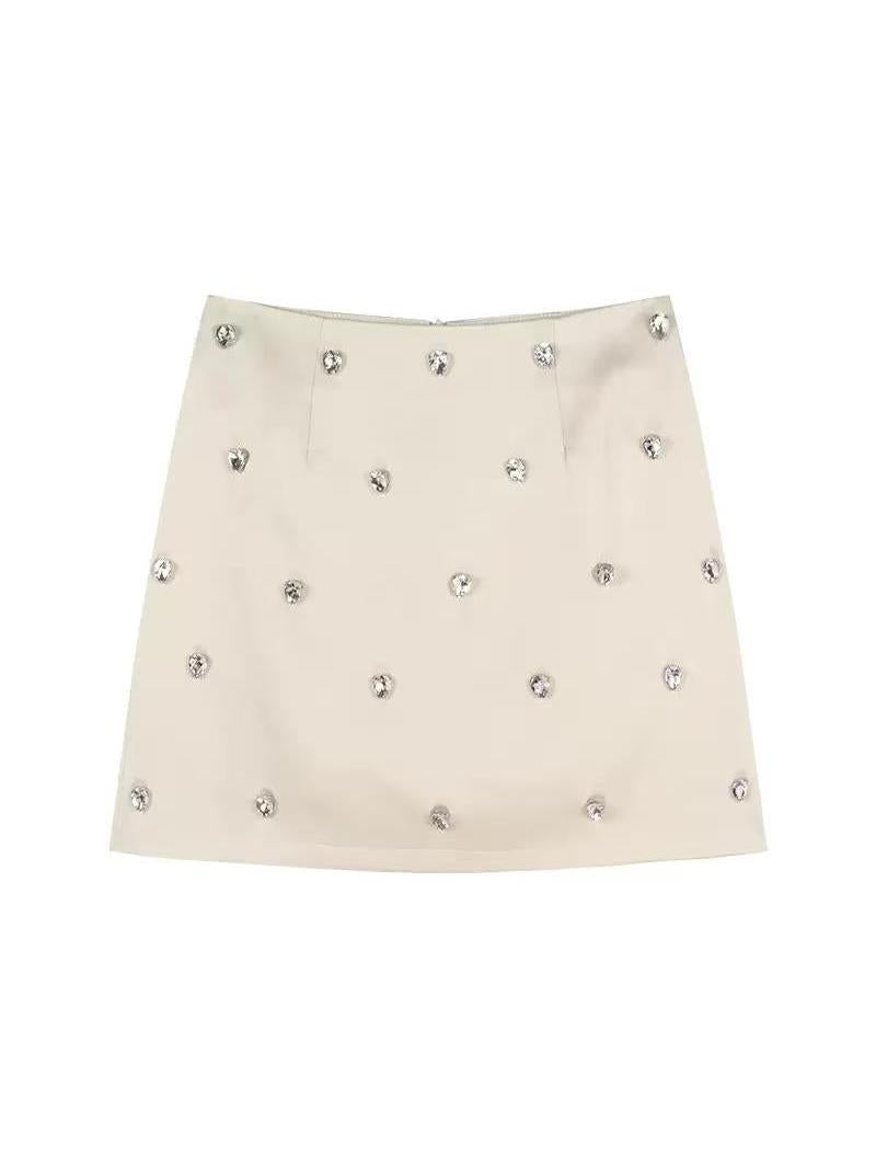 Beige satin mini A-line skirt with scattered clear crystal rhinestones.