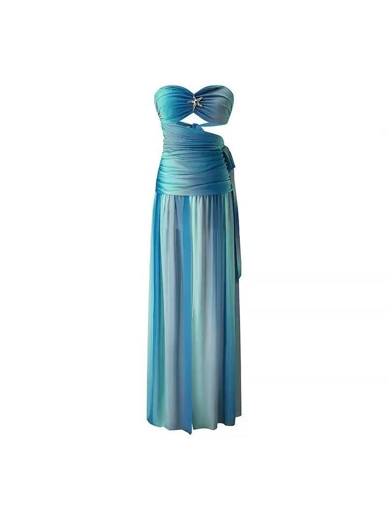 Strapless ombré ruched chiffon maxi dress with twisted bust, jeweled centerpiece, and flowing turquoise-to-navy skirt.