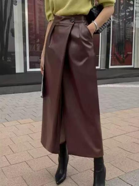 Dark burgundy faux-leather wrap-front midi skirt with front overlap, paired with a lime top and black ankle boots.