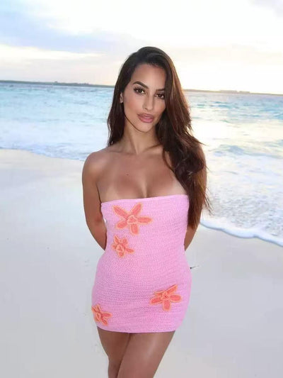 Bahama Bloom Crochet Mini Dress; pink crochet fabric with orange floral appliques on the beach.