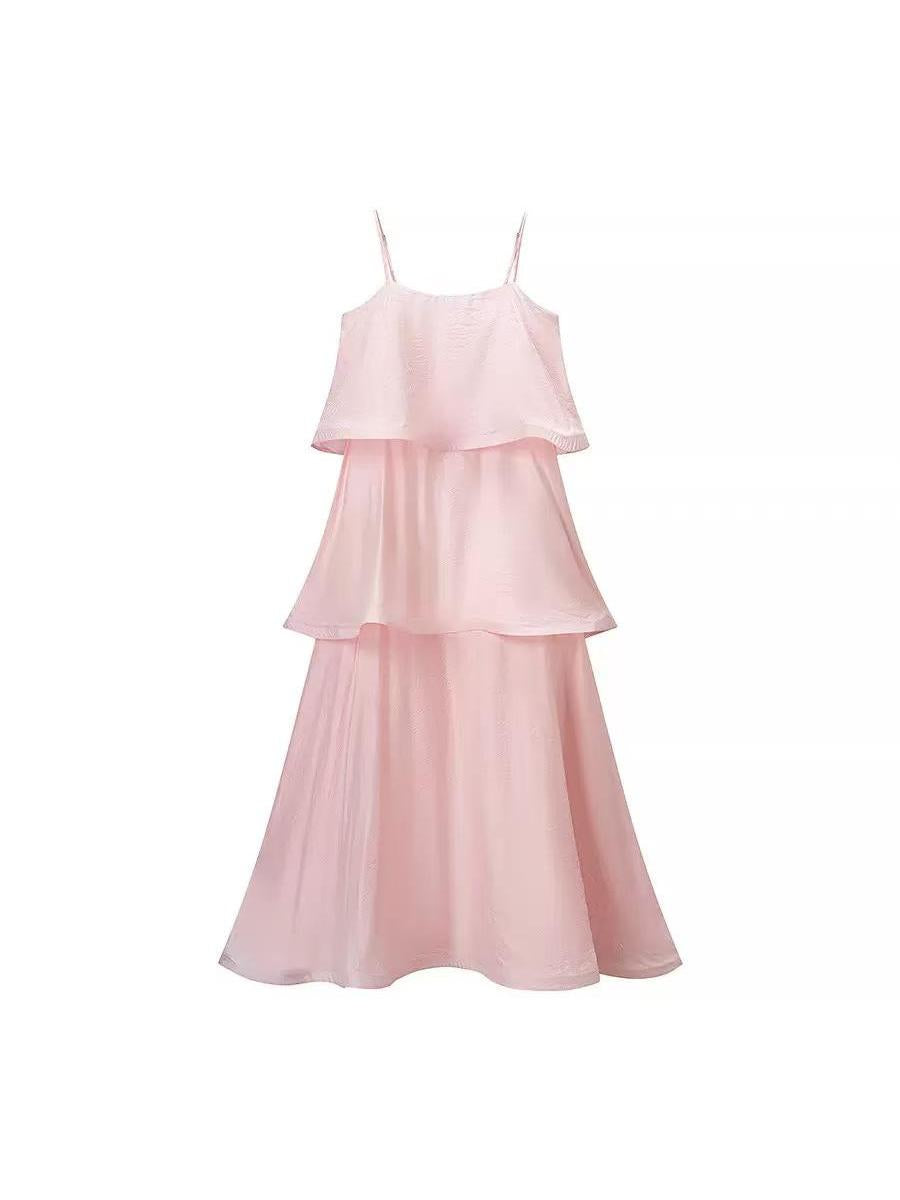 Blush pink spaghetti-strap maxi dress with layered ruffle tiers and flowing floor-length skirt.