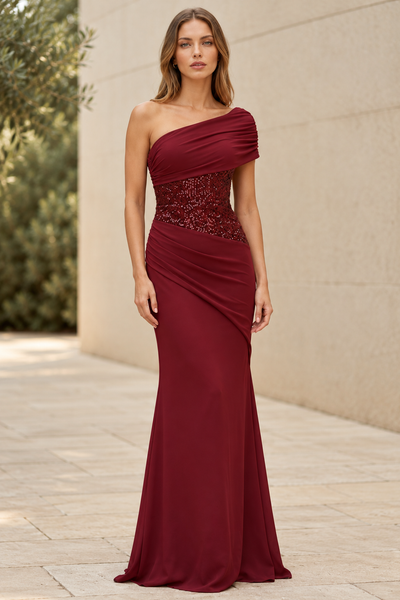 One Shoulder Sequin Corset Gown by Exclusives in burgundy; floor-length dress with ruched bodice and draped skirt