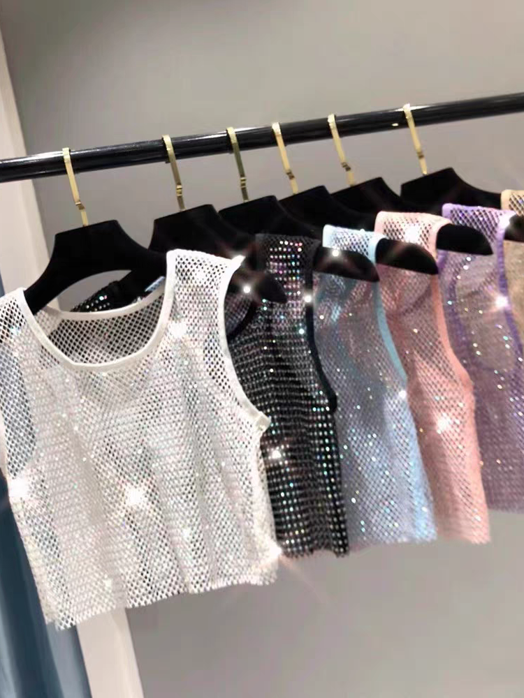 Seven sleeveless rhinestone crop tank tops on hangers in white, black, silver, blue, pink, lavender, and champagne