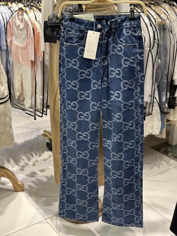 Denim printed wide-leg pants with Gucci monogram pattern in blue denim, on sale