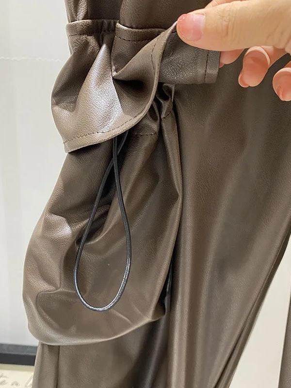 Faux leather cargo pants in brown with a cinched waist and black drawstring.