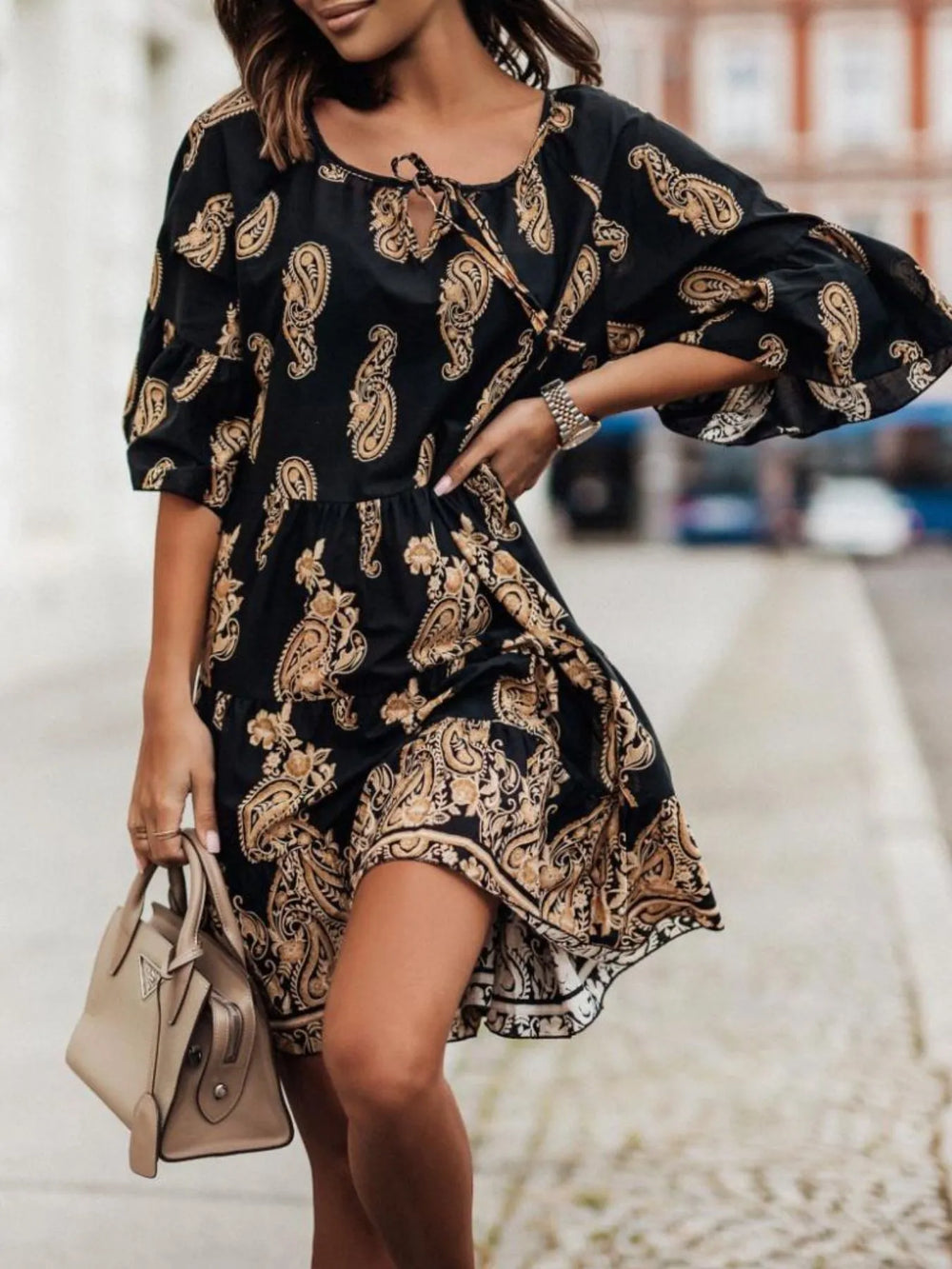 Paisley Print A-Line Dress on sale in black with gold paisley pattern, tie-neck, puff sleeves, knee-length.