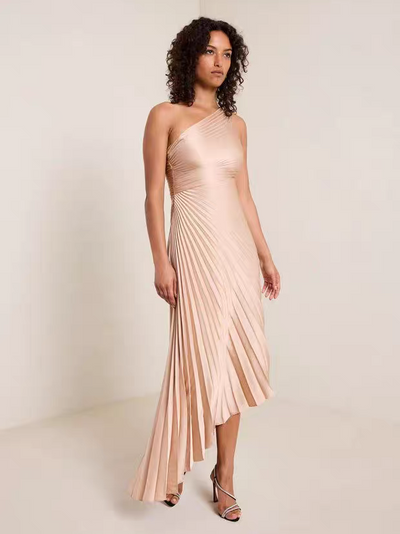 One-shoulder sun-pleated brown satin dress with flowing asymmetrical hem.