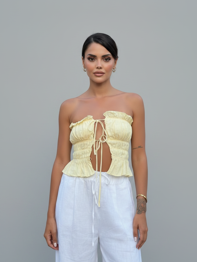Whimsy Ruffle Cropped Top by Exclusives, pale yellow strapless tank top with front ties and ruffled detailing.