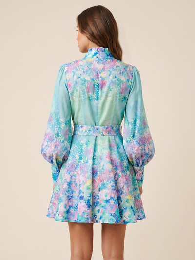 Green floral print A-line dress with belt, back view; pastel blue-green hues and purple accents