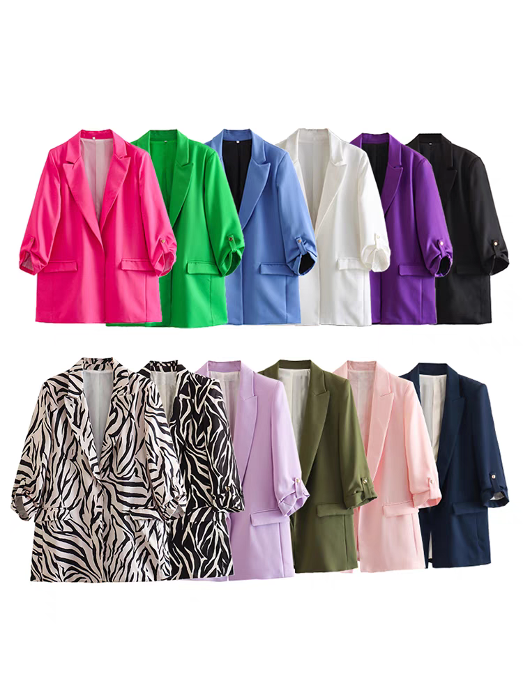 Two rows of blazers with folded sleeves in vivid colors, including zebra-print and pastel shades.
