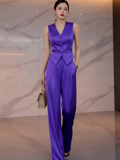 Waist Coat Vest & Wide Leg Pants Coord Set (two-piece) by Exclusives in purple satin, model with beige handbag.