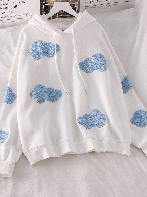 White hoodie with light blue fluffy cloud patches scattered across the front and sleeves; drawstring hood, relaxed fit.