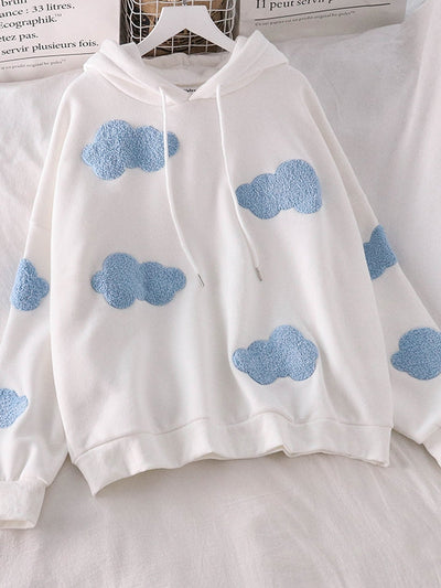 White hoodie with light blue fluffy cloud patches scattered across the front and sleeves; drawstring hood, relaxed fit.