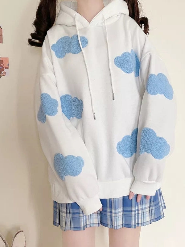 White oversized hoodie with light blue cloud patches scattered on sleeves and chest, with a drawstring hood.