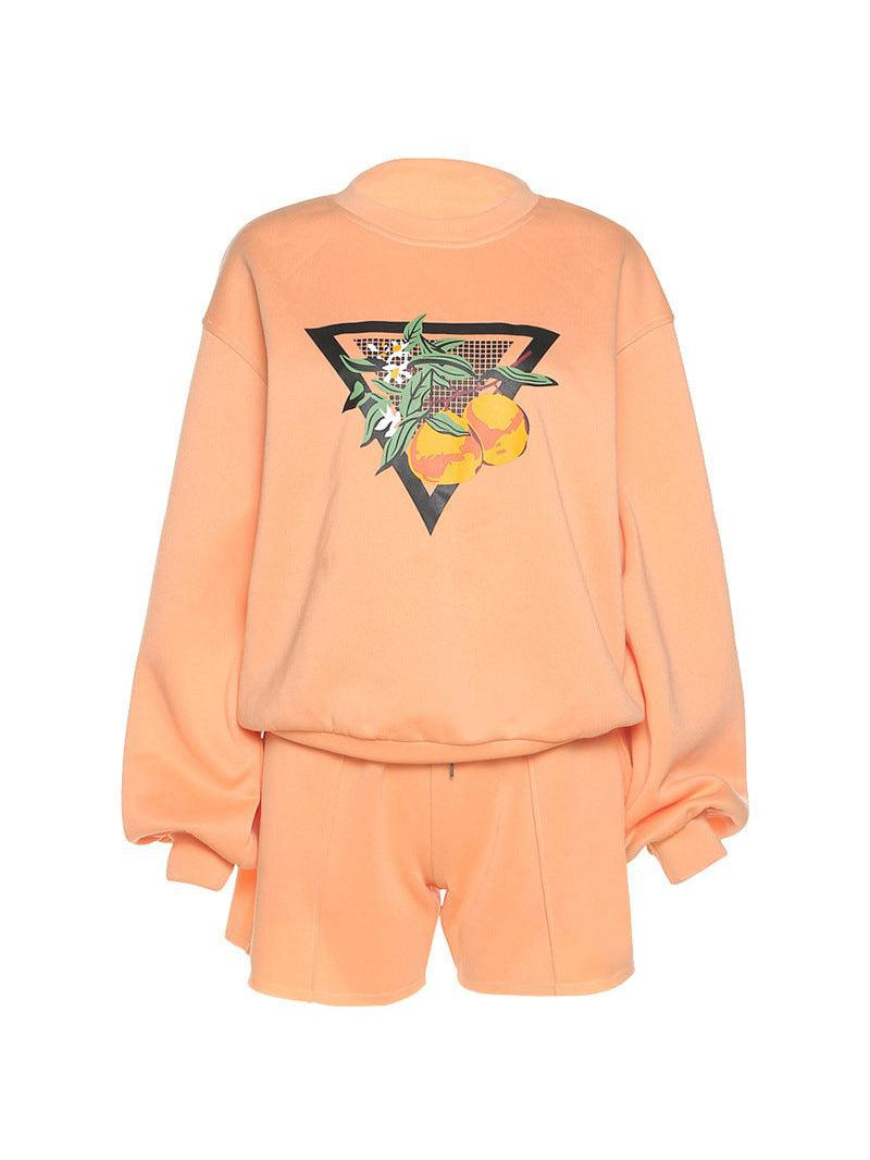 Peach co-ord: long batwing-sleeve sweatshirt with back triangle graphic of leaves and oranges, plus peach shorts.
