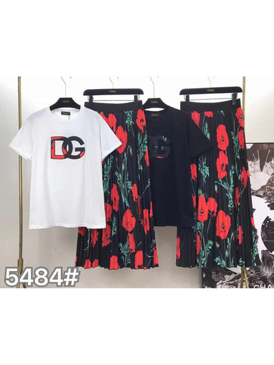 White DG logo T-shirt paired with a black top and black floral skirts with red flowers on a clothing rack.