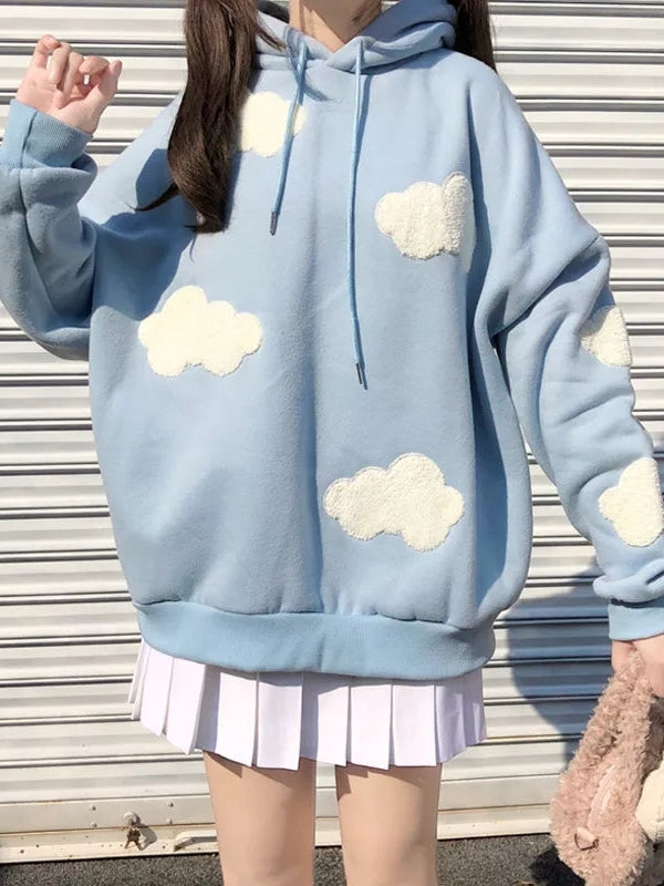 Light blue oversized hoodie with white fluffy cloud patches and drawstrings, paired with a white pleated skirt.