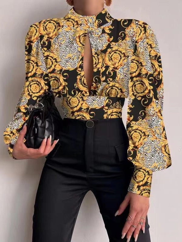 Black satin crop top with bold yellow floral and leopard print, high neck with front keyhole, and puff sleeves.