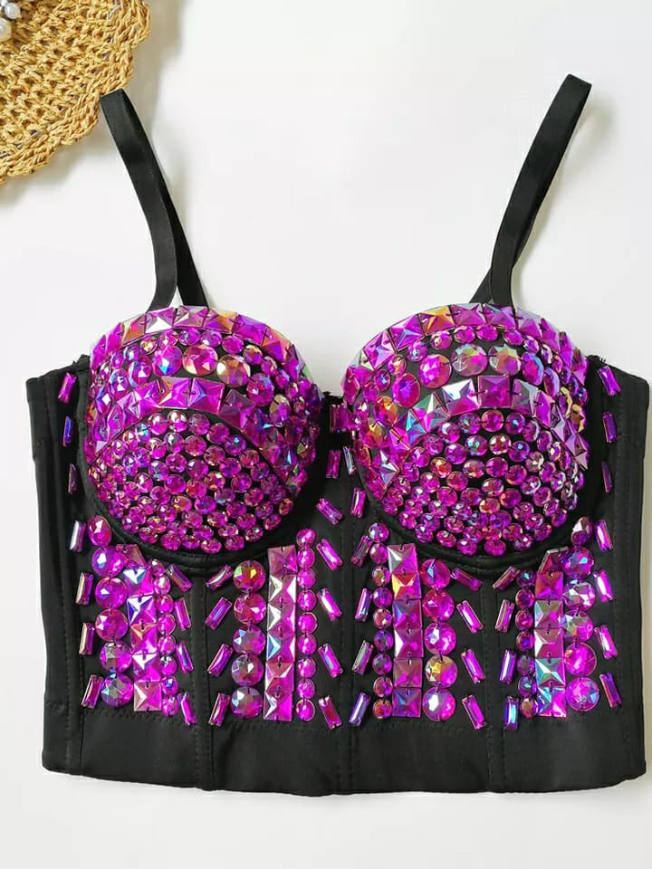 Black bustier with magenta and purple crystal cups and studded panels; dense rhinestones cover bodice; thin straps.