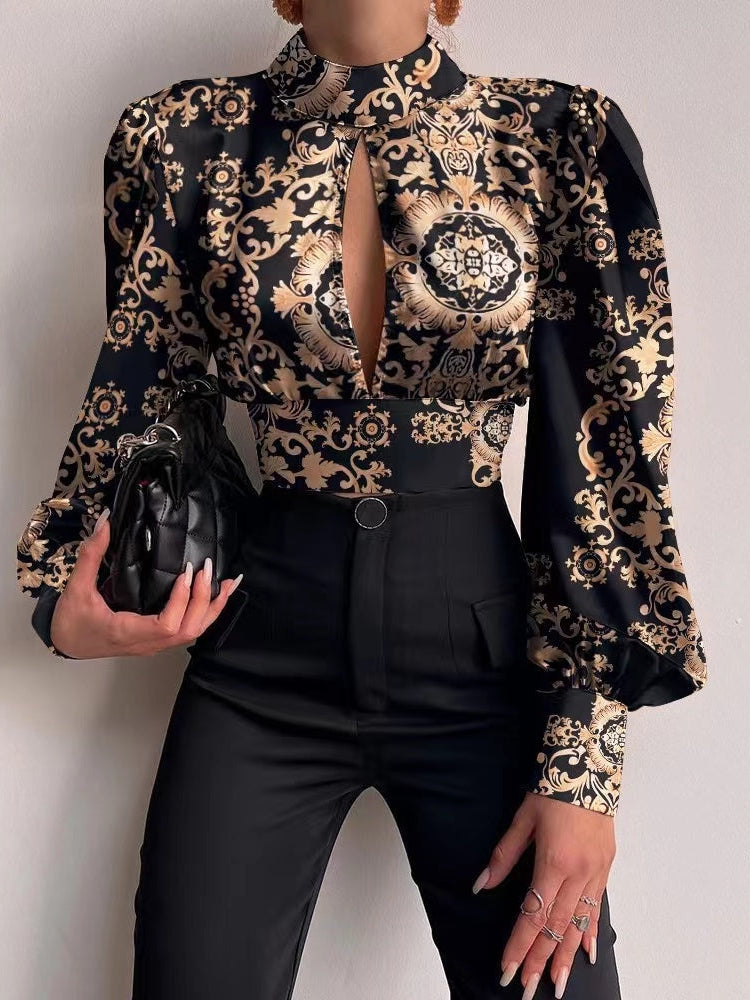 Black satin crop top with gold baroque floral pattern, high neck, front keyhole slit, and puff sleeves.