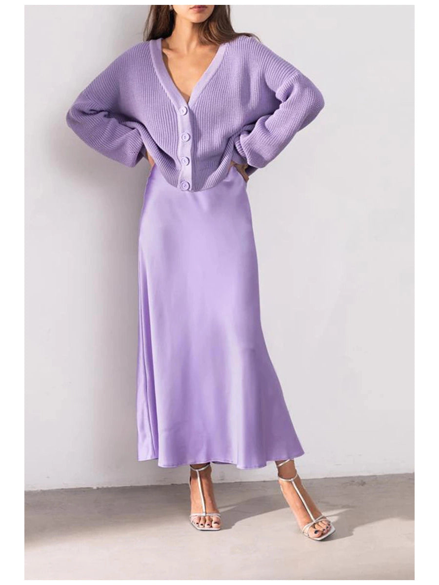 Lilac satin A-line maxi skirt with a matching chunky knit cardigan; oversized sleeves and front buttons.