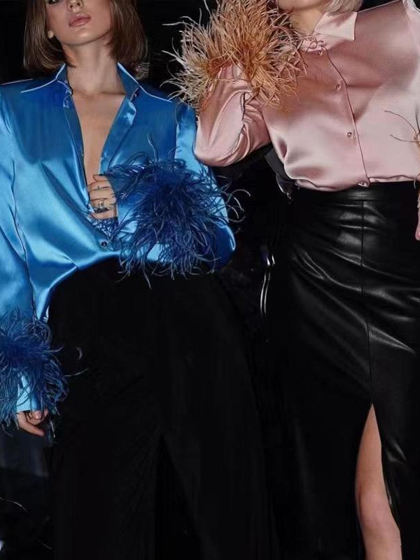 Satin shirts with feathered fur sleeves: blue with blue feathers and pink with peach feathers, paired with black skirts